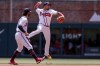 Atlanta Braves second baseman Orlando Arcia, right, throws to first for an out against Arizona Diamondbacks' Josh Rojas during the fourth inning of a baseball game Sunday, July 31, 2022, in Atlanta. (AP Photo/Butch Dill)