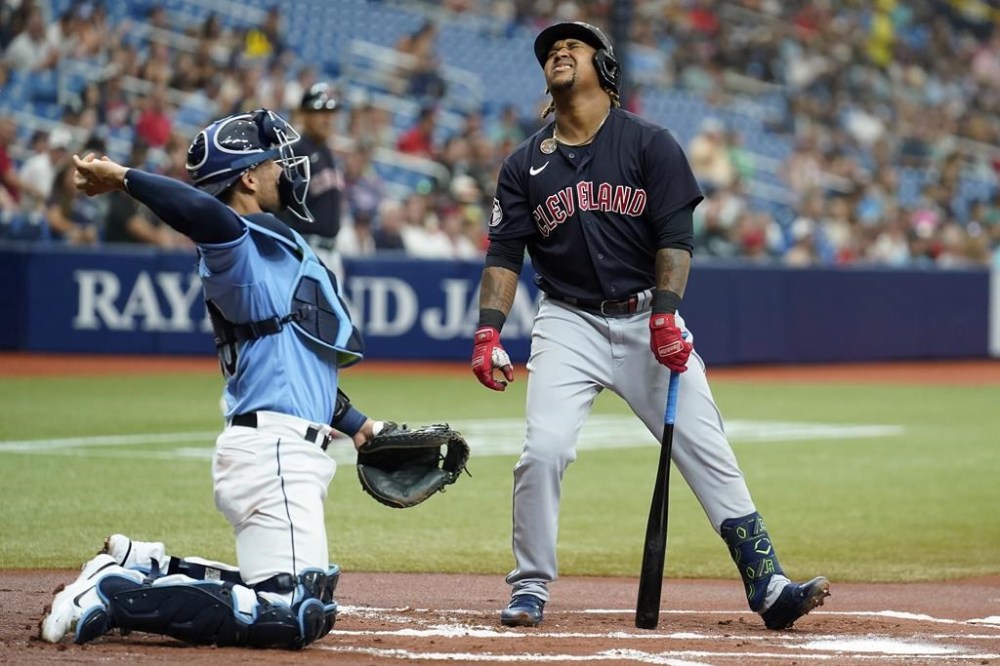 Cleveland Guardians' Jose Ramirez, right, reacts after striking out against Tampa Bay Rays starting pitcher Shane McClanahan during the first inning of a baseball game Sunday, July 31, 2022, in St. Petersburg, Fla. Catching for the Rays is catcher Rene Pinto. (AP Photo/Chris O'Meara)
