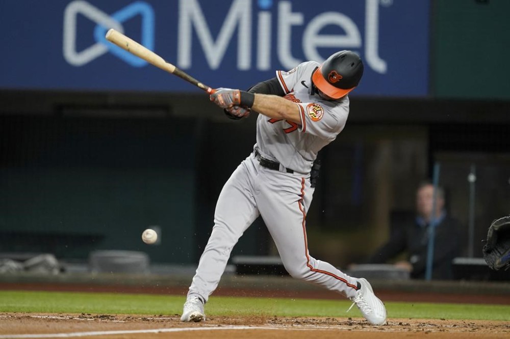 Baltimore Orioles' Terrin Vavra follows through on a single to first in the second inning of a baseball game against the Texas Rangers, Monday, Aug. 1, 2022, in Arlington, Texas. The hit was Vavra's first major league hit. (AP Photo/Tony Gutierrez)