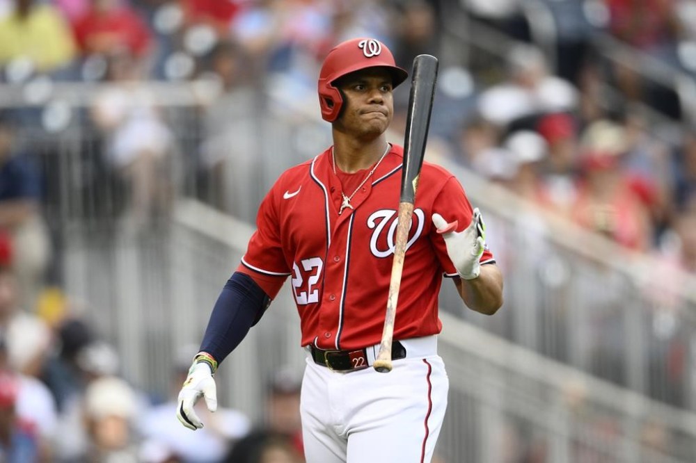 Washington Nationals' Juan Soto reacts as he walks back to the dugout after he was called out on strikes during the ninth inning of a baseball game against the St. Louis Cardinals, Sunday, July 31, 2022, in Washington. (AP Photo/Nick Wass)