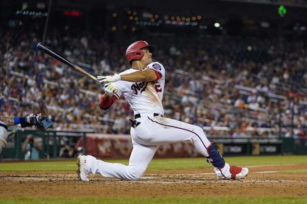 FILE - Washington Nationals' Juan Soto bats during a baseball game against the New York Mets at Nationals Park, Monday, Aug. 1, 2022, in Washington. the Nationals on Tuesday, Aug. 2, 2022, in one of baseball's biggest deals at the trade deadline, vaulting their postseason chances by adding a World Series champion who is one of baseball’s best hitters in his early 20s. A person with direct knowledge of the move told The Associated Press the Padres and Nationals have agreed to a multiplayer deal contingent on San Diego first baseman Eric Hosmer waiving his no-trade provision. The person spoke to the AP on condition of anonymity because negotiations were ongoing. (AP Photo/Alex Brandon, File)
