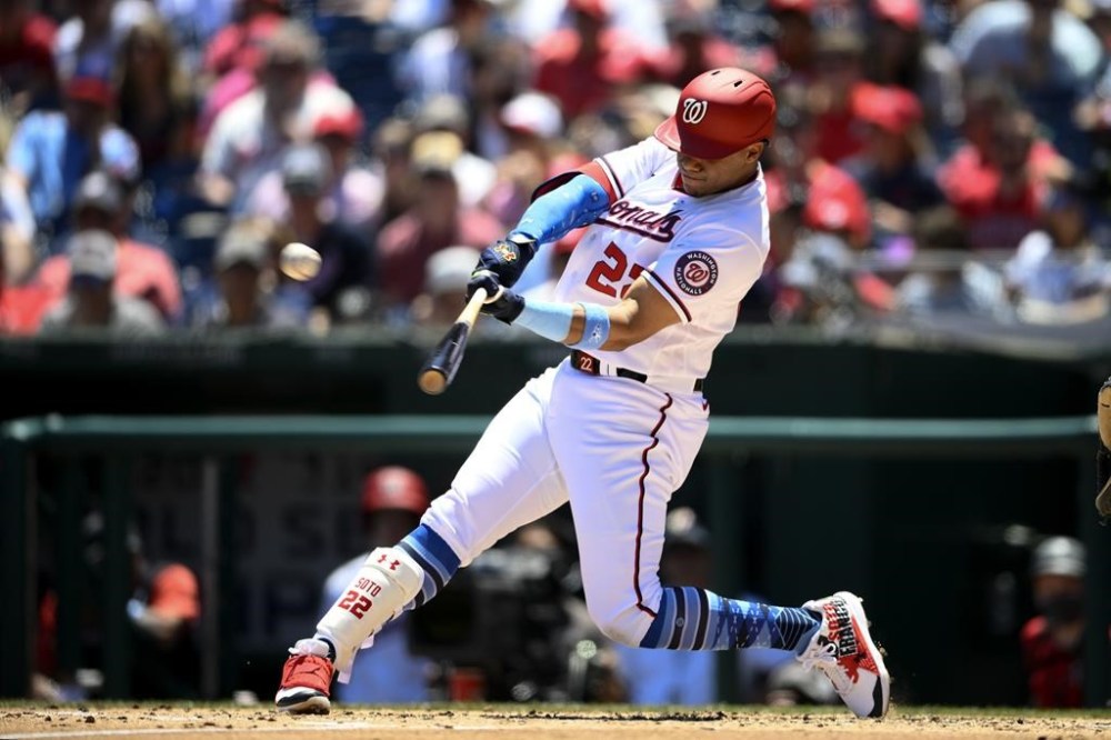 FILE - Washington Nationals' Juan Soto hits a three-run home run during the second inning of a baseball game against the Philadelphia Phillies, on June 19, 2022, in Washington. The San Diego Padres acquired superstar outfielder Juan Soto from the Nationals on Tuesday, Aug. 2, 2022, in one of baseball's biggest deals at the trade deadline, vaulting their postseason chances by adding one of the game's best young hitters. (AP Photo/Nick Wass, File)