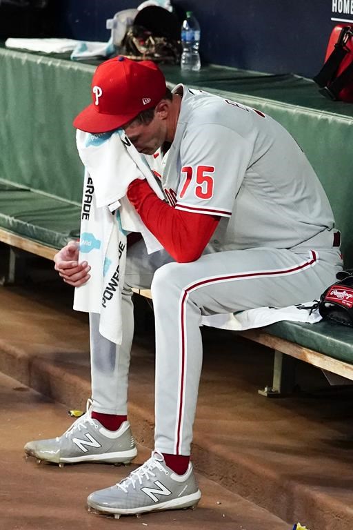 Philadelphia Phillies relief pitcher Connor Brogdon (75) sits on the bench after the Phillies allowed two run in the third inning of a baseball game against the Atlanta Braves Tuesday, Aug. 2, 2022, in Atlanta. (AP Photo/John Bazemore)