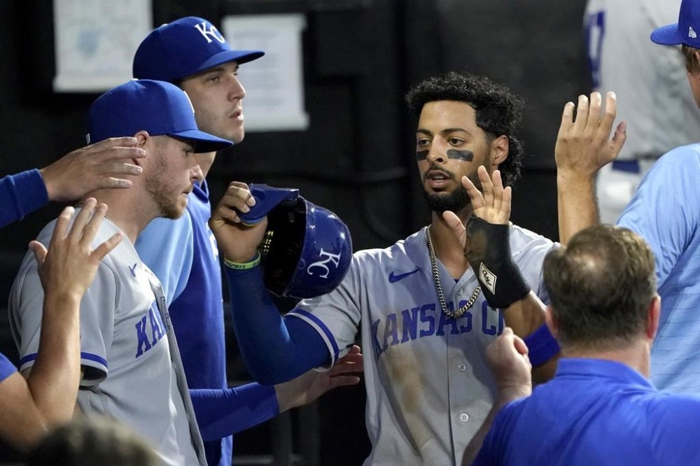 Kansas City Royals' MJ Melendez is greeted in the dugout after scoring on Hunter Dozier's double off Chicago White Sox starting pitcher Lucas Giolito, during the third inning of a baseball game Tuesday, Aug. 2, 2022, in Chicago. (AP Photo/Charles Rex Arbogast)