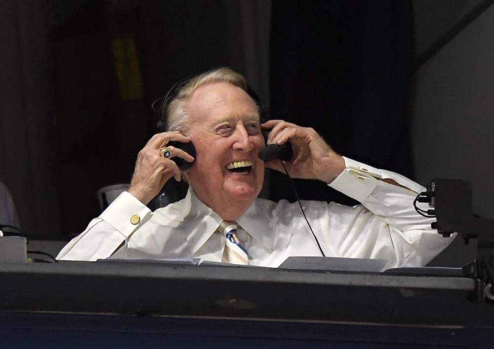 FILE - In this Monday, Sept. 19, 2016, file photo, Los Angeles Dodgers' Hall of Fame announcer Vin Scully puts his headset on prior to a baseball game between the Los Angeles Dodgers and the San Francisco Giants in Los Angeles.  Scully, whose dulcet tones provided the soundtrack of summer while entertaining and informing Dodgers fans in Brooklyn and Los Angeles for 67 years, died Tuesday night, Aug. 2, 2022, the team said. He was 94. (AP Photo/Mark J. Terrill, File)