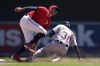Detroit Tigers' Harold Castro is tagged out by Minnesota Twins shortstop Carlos Correa while attempting to steal second base in the sixth inning of a baseball game Wednesday, Aug. 3, 2022, in Minneapolis. (AP Photo/Abbie Parr)