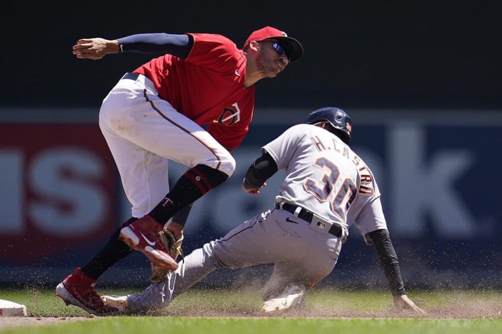 Detroit Tigers' Harold Castro is tagged out by Minnesota Twins shortstop Carlos Correa while attempting to steal second base in the sixth inning of a baseball game Wednesday, Aug. 3, 2022, in Minneapolis. (AP Photo/Abbie Parr)