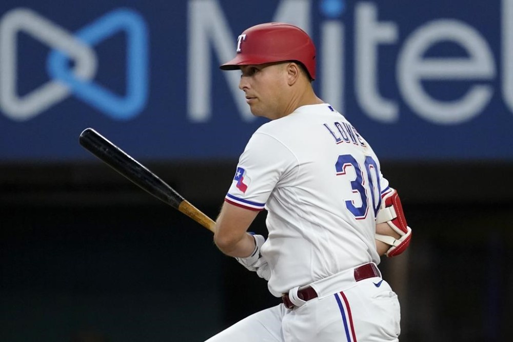 Texas Rangers' Nathaniel Lowe follows through on a swing in the third inning of a baseball game against the Baltimore Orioles, Wednesday, Aug. 3, 2022, in Arlington, Texas. Lowe reached first on a fielding error by shortstop Jorge Mateo. (AP Photo/Tony Gutierrez)