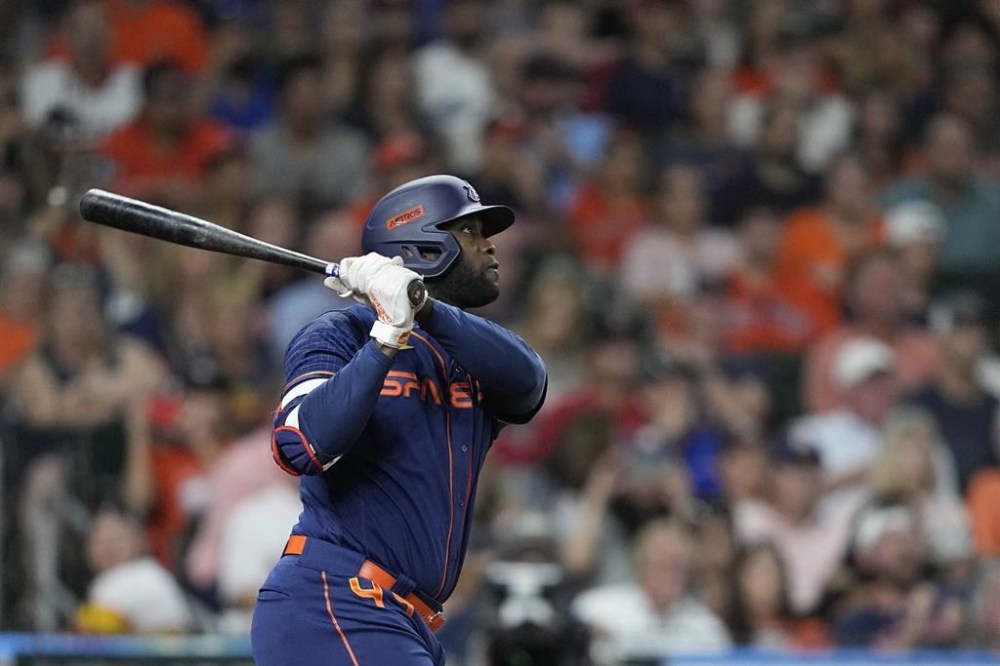 Houston Astros' Yordan Alvarez hits a sacrifice fly to score Jose Altuve during the third inning of a baseball game against the Boston Red Sox Monday, Aug. 1, 2022, in Houston. (AP Photo/David J. Phillip)