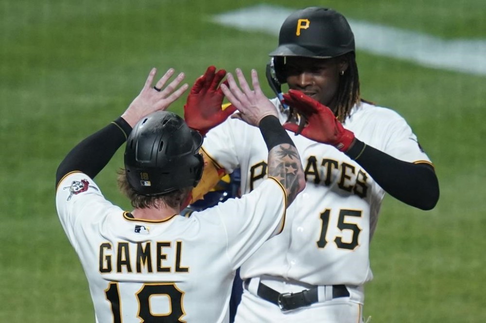 Pittsburgh Pirates' Oneil Cruz, right, celebrates with Ben Gamel (18) after driving him in with a two-run home run against the Milwaukee Brewers during the seventh inning of a baseball game Wednesday, Aug. 3, 2022, in Pittsburgh. (AP Photo/Keith Srakocic)