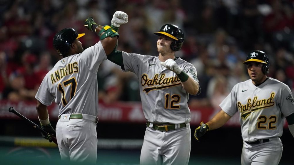 Oakland Athletics' Sean Murphy (12) celebrates his two-run home run with Elvis Andrus (17) during the sixth inning of the team's baseball game against the Los Angeles Angels on Wednesday, Aug. 3, 2022, in Anaheim, Calif. (AP Photo/Marcio Jose Sanchez)