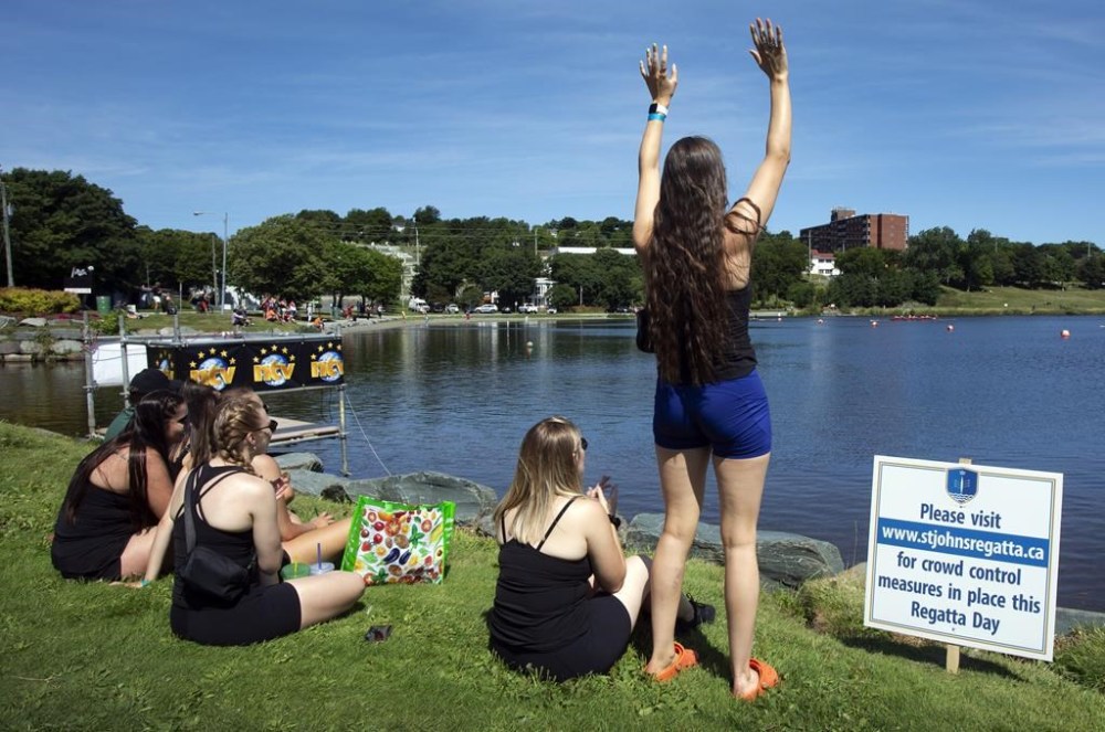History will be made today at a 204-year-old rowing race in St. John's as four women's teams tackle a course that has historically been reserved for men. A female rowing team watches a race during the Royal St. John's Regatta at Quidi Vidi Lake in St. John's N.L., on Thursday, August 5, 2021. THE CANADIAN PRESS/Paul Daly