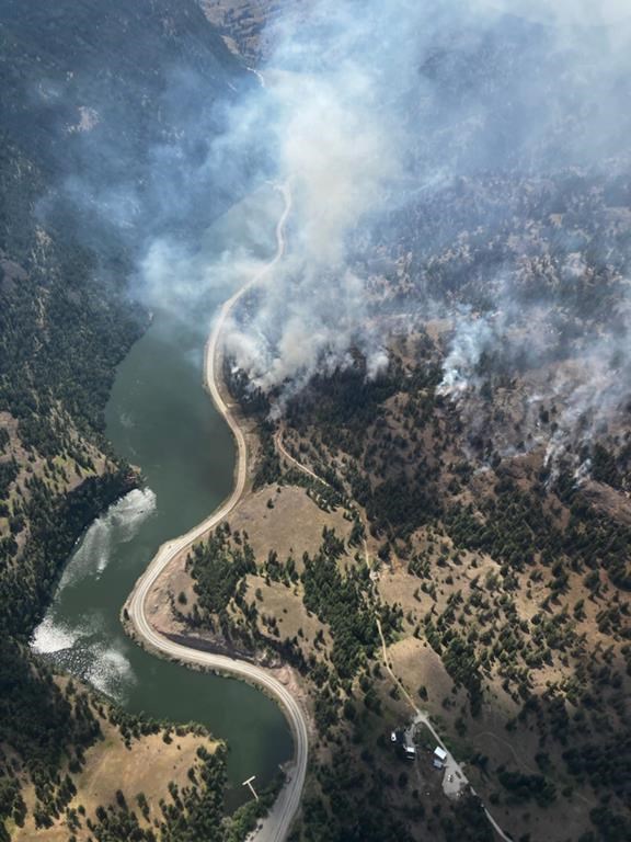 Smoke from a wildfire is visible along Highway 3A at the north end of Yellow Lake in British Columbia in an Aug.3, 2022 handout photo. THE CANADIAN PRESS/HO-BC Wildfire Service **MANDATORY CREDIT**