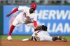 Philadelphia Phillies shortstop Didi Gregorius, left, tags out Atlanta Braves' Dansby Swanson after he tried to steal second during the seventh inning of a baseball game, Tuesday, July 26, 2022, in Philadelphia. (AP Photo/Matt Slocum)