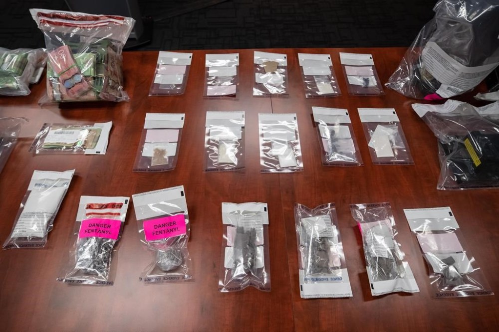 A seizure of illegal drugs and cash is displayed during a news conference at Surrey RCMP Headquarters, in Surrey, B.C., on Thursday, September 3, 2020. As Toronto waits to hear whether the federal government will grant its request to decriminalize the possession of illicit drugs for personal use in the city, harm reduction advocates say approval is urgently needed as governments fail to match the gravity of the opioid crisis. THE CANADIAN PRESS/Darryl Dyck
