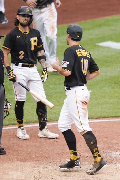 Pittsburgh Pirates' Michael Chavis (2) scores from third on a wild pitch in the 10th inning of a baseball game against the Milwaukee Brewers, Thursday, Aug. 4, 2022, in Pittsburgh. The Pirates won 5-4.(AP Photo/Keith Srakocic)