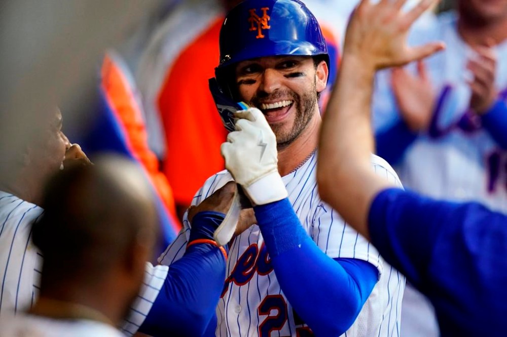 New York Mets' Tyler Naquin celebrates with teammates after hitting a home run during the second inning of the team's baseball game against the Atlanta Braves on Thursday, Aug. 4, 2022, in New York. (AP Photo/Frank Franklin II)