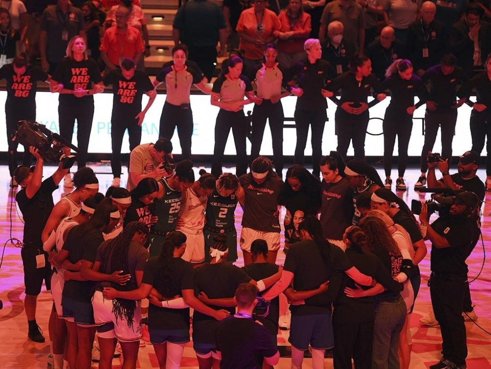 Players with the Connecticut Sun and Phoenix Mercury link arms for 42 seconds in honor of Phoenix Mercury center Brittney Griner before a WNBA basketball game Thursday, Aug. 4, 2022, in Uncasville, Conn. Griner was convicted Thursday in Russia of drug possession and smuggling and was sentenced to nine years behind bars. (Sarah Gordon/The Day via AP)