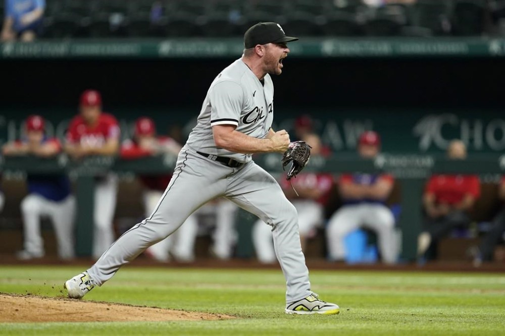 Chicago White Sox relief pitcher Liam Hendriks celebrates after getting the final out in the team's baseball game against the Texas Rangers, Friday, Aug. 5, 2022, in Arlington, Texas. The White Sox won 2-1. (AP Photo/Tony Gutierrez)