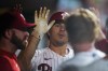 Philadelphia Phillies' J.T. Realmuto is congratulated for a two-run home run off Washington Nationals' Carl Edwards Jr. during the sixth inning of a baseball game Saturday, Aug. 6, 2022, in Philadelphia. (AP Photo/Matt Rourke)