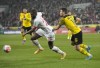 FILE - Cologne's Anthony Modeste, left, and Dortmund's Raphael Guerreiro, right, challenge for the ball during the German Bundesliga soccer match between 1.FC Cologne and Borussia Dortmund in Cologne, Germany, Sunday, March 20, 2022. Borussia Dortmund is on verge of signing French forward Anthony Modeste from Bundesliga rival Cologne. Cologne said Sunday, Aug. 7, 2022, that it had received an offer for the 34-year-old Modeste and agreed on a transfer. (AP Photo/Martin Meissner, File)
