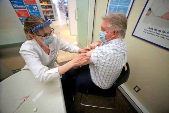 Pharmacist Kimberly Thiessen prepares to give Rob Robinson, 51, an AstraZeneca dose in Brandon on Monday. (Tyler Clarke / Brandon Sun)