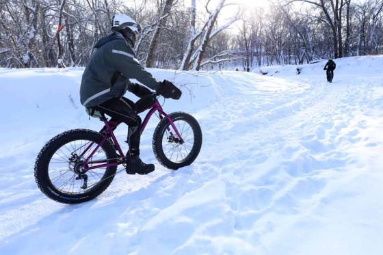 Outdoor enthusiasts ride their fat bikes along the Seine River on Wednesday. (Ruth Bonneville / Winnipeg Free Press)