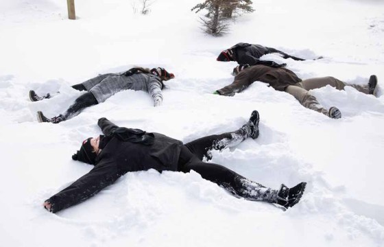 Insurance brokers Rosealie Van Deynze (from left), Chelsea Scheer-Kosowan, Suzanne Percival and Vincent Kluz take a break from work to make snow angels on Monday. The CancerCare Manitoba Foundation is raising funds by asking people to make snow angels in memory of loved ones. For more information, go to http://wfp.to/1kb. (Jessica Lee / Winnipeg Free Press)