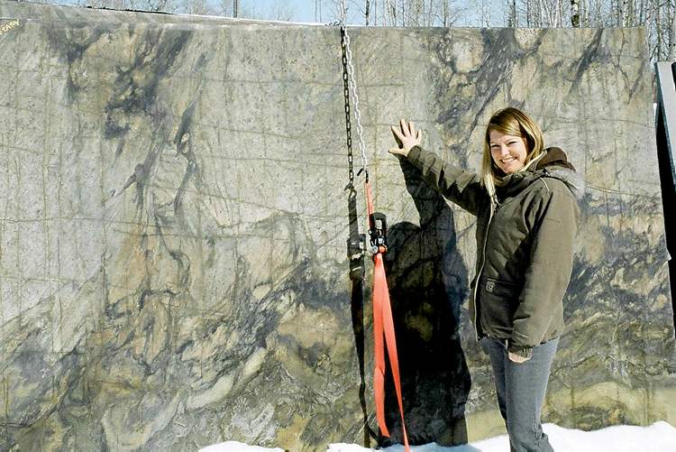 Jaime Pineau of Granite Mountain Stone Design with an example of Black Fantasy solid granite.