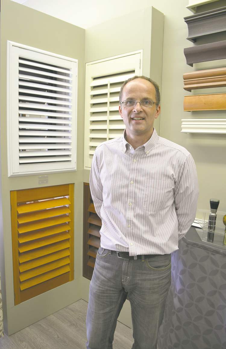 Budget Blinds owner Ron Hermann with a display of shutters at his store on Henderson Highway.