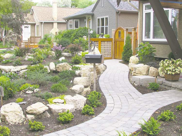 Colleen Zacharias
Limestone is the preferred material in this three-tiered Fort Garry rock garden, newly planted with an assortment of perennials and small shrubs.  Curved pathways soften the hard edges.