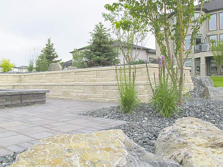 Colleen Zacharias
Granite boulders punctuate this sloping urban landscape without detracting from any of the other hardscaping elements. Perennial beds have been filled with crushed granite for both an aesthetic and practical purpose.