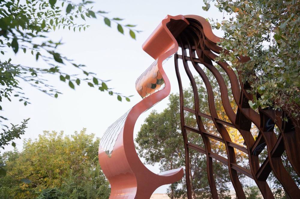 The Niimaamaa sculpture at The Forks rests at the entry to Niizhoziibean, a natural area that now includes the Gathering Space, a teaching lodge built by Indigenous craftspeople.