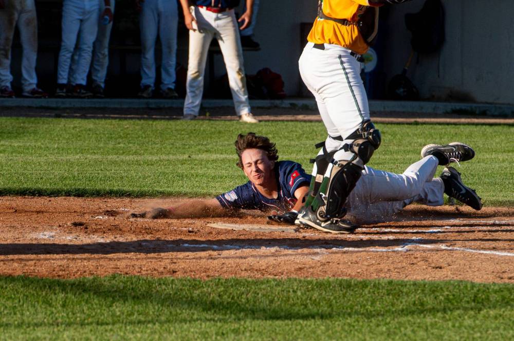 Elmwood Giants' Nixon Carriere slides into home Thursday in the first game of the MJBL final against the St. James A's at Optimist Field. (Mike Sudoma/Winnipeg Free Press)