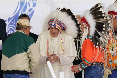 ERIC GAY / ASSOCIATED PRESS PHOTO
                                Pope Francis dons a headdress during a visit with Indigenous peoples at Maskwaci, the former Ermineskin Residential School in Maskwacis, Alberta. Pope Francis traveled to Canada to apologize to Indigenous peoples for the abuses committed by Catholic missionaries in the country&rsquo;s notorious residential schools.
