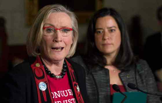 Adrian Wyld / THE CANADIAN PRESSMinister of Justice and Attorney General of Canada Jody Wilson-Raybould looks on as Minister of Indigenous and Northern Affairs Carolyn Bennett responds to a question during an announcement for a Missing and Murdered Indigenous Women inquiry during a news conference in the Foyer of the House of Commons Tuesday on Parliament Hill in Ottawa.