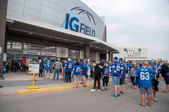 Bombers fans line up outside IG Field for the opening game of the CFL season last week. (Alex Lupul / Winnipeg Free Press files)
