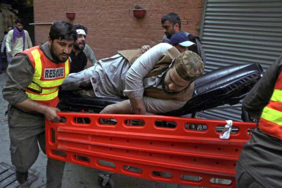 Muhammad Sajjad / The Associated PressAn injured man is taken from the site of the explosion. (Muhammad Sajjad / The Associated Press)