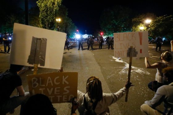 Alex Brandon / The Associated PressDemonstrators protest the death of George Floyd, Sunday, near the White House in Washington. Floyd died after being restrained by Minneapolis police officers.