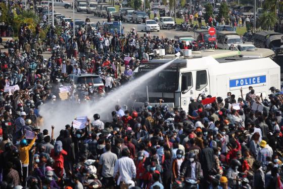 CPA police truck uses a water cannon on protesters in Myanmar on Monday. (The Associated Press)