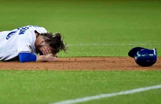 Nathan Denette/The Canadian Press via APToronto Blue Jays' Josh Donaldson rests after a collision during a force out at second base by Texas Rangers' Rougned Odor during the fourth inning of Game 1 of the American League Division Series in Toronto on Thursday.