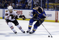 Jeff Roberson / The Associated PressChicago Blackhawks' Patrick Kane, left, reaches for St. Louis Blues' Patrik Berglund, of Sweden, during the first overtime in Game 5.