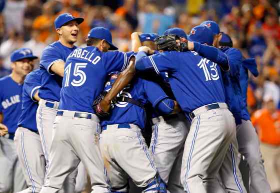 Patrick Semansky / The Associated PressMembers of the Toronto Blue Jays celebrate after winning the first baseball game of a doubleheader against the Baltimore Orioles, Wednesday, in Baltimore.