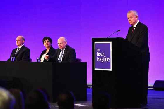 Jeff J. Mitchell / The Associated PressSir John Chilcot, right, presents the Iraq Inquiry Report at the Queen Elizabeth II Centre in London, Wednesday.
