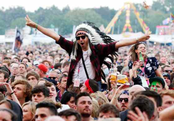 Jim Ross / Invision / The Associated Press FilesA festivalgoer in a faux indigenous headdress enjoys the performance at the Isle of Wight Festival.