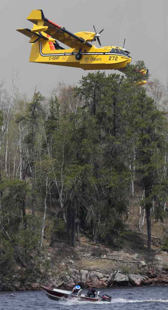 JOE BRYKSA / WINNIPEG FREE PRESSWater bombers work hard controlling forest fire hot spots on the east side of Caddy Lake Tuesday.
