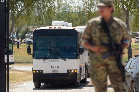CPA bus used to transport migrants departs a makeshift camp at the International Bridge in Del Rio, Texas, on Monday. (Eric Gay / The Associated Press)