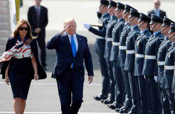 Kirsty Wigglesworth / The Associated PressPresident Donald Trump salutes an honour guard as he and first lady Melania Trump arrive at Stansted Airport in England, Monday.