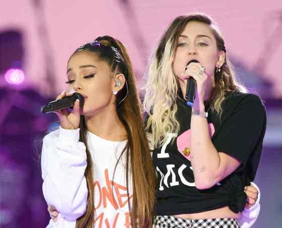 DAVE HOGAN / THE ASSOCIAITED PRESSAriana Grande, left, and Miley Cyrus perform at the One Love Manchester tribute concert.