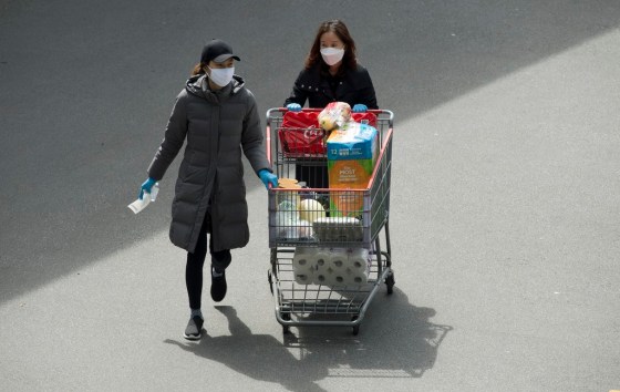 JONATHAN HAYWARD / THE CANADIAN PRESS FILESShoppers are seen wearing protective face masks as they leave a Costco in Burnaby, B.C., last week.